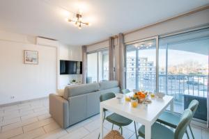 un salon avec une table et un canapé dans l'établissement Grand Studio front de mer - Climatiser avec place de parking, à La Celle-sous-Gouzon