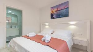 a bedroom with a bed with two towels on it at Star Hill - Makarska by Villas Guide in Slivno +47 photos