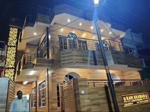 a man standing in front of a house at night at Hotel Ram Bhawan in Lucknow
