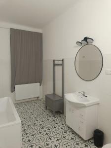 een witte badkamer met een wastafel en een spiegel bij prumyslova in Prostějov