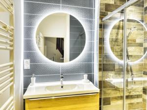 a bathroom with a sink and a mirror at Au Beau Duplex de la Basilique in Boulogne-sur-Mer +16 photos