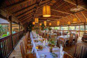 a dining room with tables and chairs in a restaurant at Karongwe - Chisomo Safari Camp in Hoedspruit