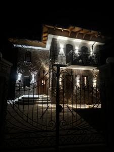 a building with a gate at night at Castle Rozafa Scutari in Voskopojë