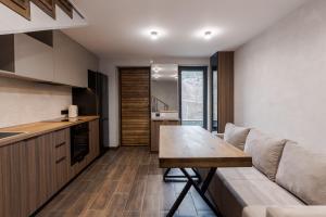 a kitchen and living room with a couch and a table at Saduba y Lukasa in Oryavchyk +16 photos