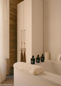 a bathroom with a bath tub with three candles on it at A galería do san Ramón in Villalba