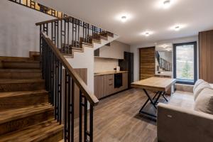 a living room with a staircase in a house at Saduba y Lukasa in Oryavchyk