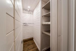 a walk in closet with white walls and wood floors at Saduba y Lukasa in Oryavchyk