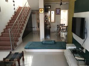 a living room with a couch in the middle of a room at Keshav in Bhuj