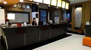 une femme assise à un comptoir dans un restaurant dans l'établissement Majestic Hotel Manila - Formerly Octagon Mansion Hotel Manila, à Manille