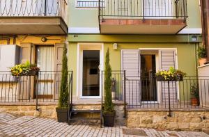 a building with potted plants on the balconies at Albergo Covili in Pavullo nel Frignano