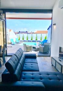 a living room with a couch and a patio at Janota Week with pool in Setúbal
