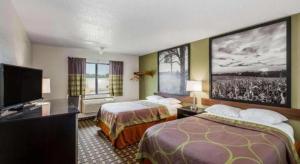 a hotel room with two beds and a flat screen tv at Super 8 By Wyndham Wayne in Wayne
