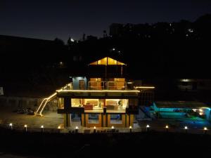 a large building with a lit up tower at night at Perry's Cottage in Faigul
