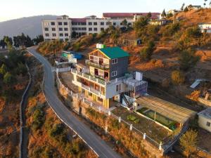 a house on a hill next to a road at Perry's Cottage in Faigul +14 photos