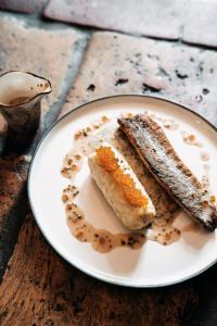 a plate with two pieces of food on a table at mein werder - hotel am markt in Werder