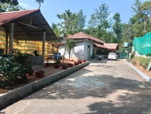 a house with a car parked in the driveway at Anurastays in Mudigere +8 photos