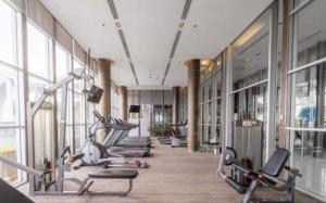 a gym with a row of exercise bikes in a room at The Onnut Nest 1BR Sofa Bed Onnut BTS 50m in Bangkok