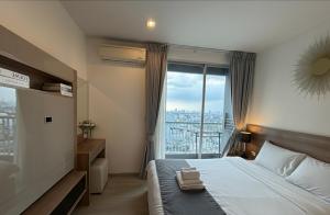 a bedroom with a bed and a large window at The Onnut Nest 1BR Sofa Bed Onnut BTS 50m in Bangkok +18 photos
