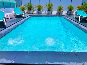 a swimming pool with blue chairs at Luxury Villa with Private Pool e Jacuzzi Year-Round a 25 min de Lisboa in Setúbal