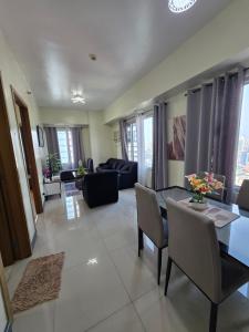 a living room with a table and chairs at 8 Adriatico Condominium 1BR in Sampong