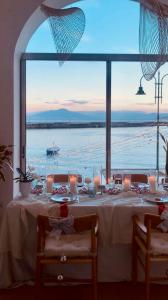 a dining table with a view of the ocean at ZOOM CAPRI home in Capri