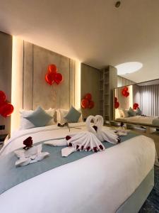 a bedroom with swans made out of towels on a bed at Rose Garden Hotel فندق روز جاردن in Riyadh +168 photos