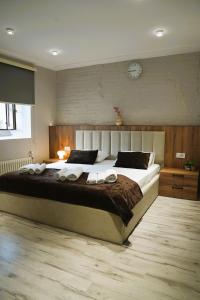 a bedroom with a large bed with two towels on it at RA Boutique Hotel in Baku