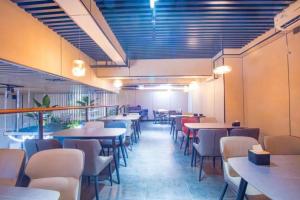 ein Speisesaal mit Tischen und Stühlen in einem Restaurant in der Unterkunft Silver Art Hotel in Zhuhai