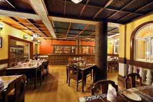 a dining room with tables and chairs in a restaurant at Casa De Goa - Boutique Resort - Calangute in Calangute