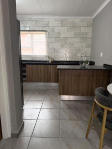 a kitchen with a tile floor and a counter top at Cozzy home in Polokwane