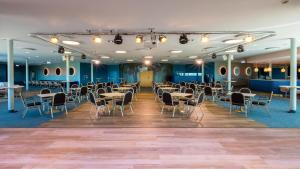 a banquet hall with tables and chairs in a room at Hestia Hotel Strand in Pärnu