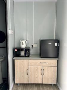a tv sitting on top of a wooden cabinet at TeeDo Zzz in Parit Buntar