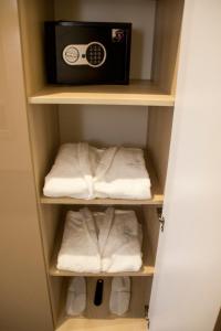 a closet with towels and a radio in it at Hotel Versailles in Lutsk