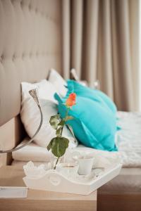 a blue and white bird sitting on top of a white pillow at Hotel Versailles in Lutsk