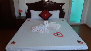 Postel nebo postele na pokoji v ubytování Mango Garden Hoi An Homestay