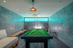 a ping pong table in a room with a ping pong ball at Villa Ashoka Canggu in Canggu
