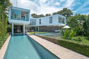 an image of a house with a swimming pool at Villa Ashoka Canggu in Canggu