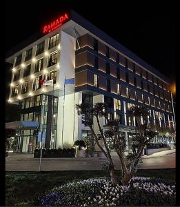 un edificio con un cartello di notte di Ramada by Wyndham Arnavutkoy a Istanbul