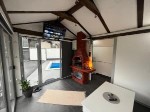 a room with a living room with a fireplace at Venero - Apartmani in Dubrave Gornje