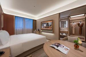 Postel nebo postele na pokoji v ubytování Orange Crystal Hotel Nanjing Jiangning Sasseur Southeast University