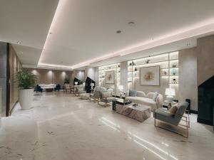 a large lobby with couches and chairs in a building at Rose Garden Hotel فندق روز جاردن in Riyadh