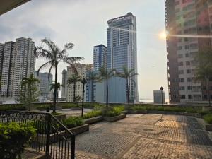 a view of a city with palm trees and buildings at Robinsons Place Residences Tower 1 in Sampong