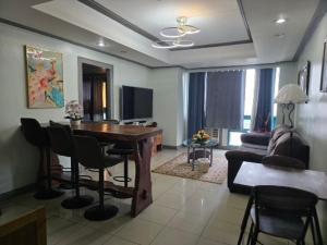 a living room with a table and chairs and a couch at Robinsons Place Residences Tower 1 in Sampong