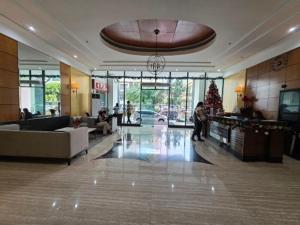 a lobby with a christmas tree in a building at Robinsons Place Residences Tower 1 in Sampong +13 photos