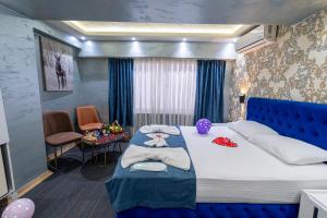 a bedroom with a large bed with a blue head board at Stay Suite Hotel in Istanbul