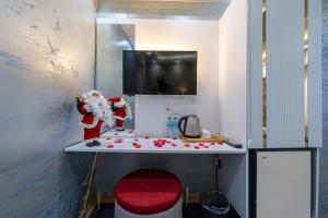 a kitchen with a counter top with a red chair at Stay Suite Hotel in Istanbul +56 photos