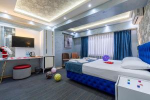 a bedroom with a bed and a desk with a television at Stay Suite Hotel in Istanbul
