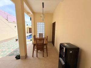 a dining room with a table and chairs and a television at Amlana villa in Gili Trawangan
