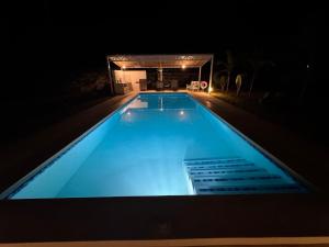a swimming pool lit up at night at Nyotas gem in Watamu