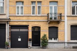 a building with two garage doors and a balcony at Modern apartment near City Centre, Luna CasaMia in Mellet